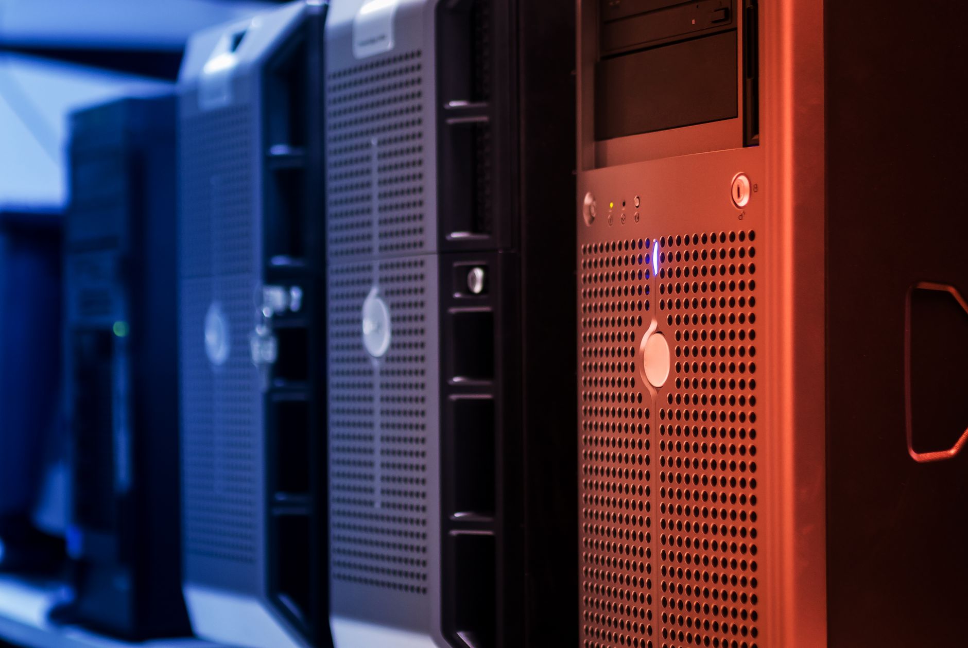 Rows of server racks with blue lighting in a modern data centre